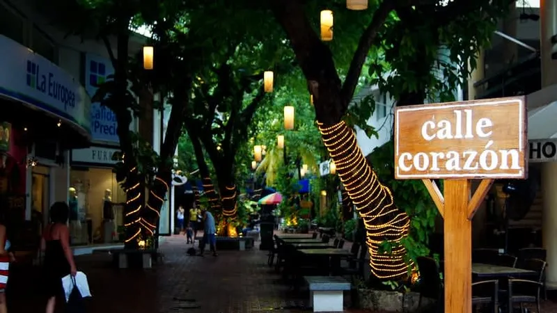 Calle Corazon shopping alley with murals, archways, and open-air dining tables