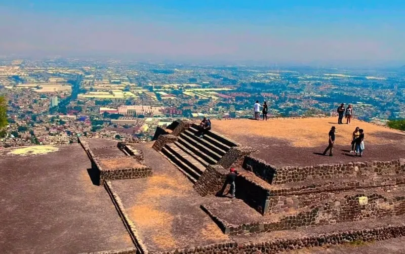 Stone temple ruins surrounded by modern Mexico City buildings