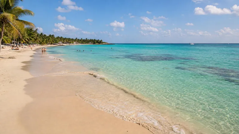 Clear turquoise water and pale sand on Akumal Bay in February