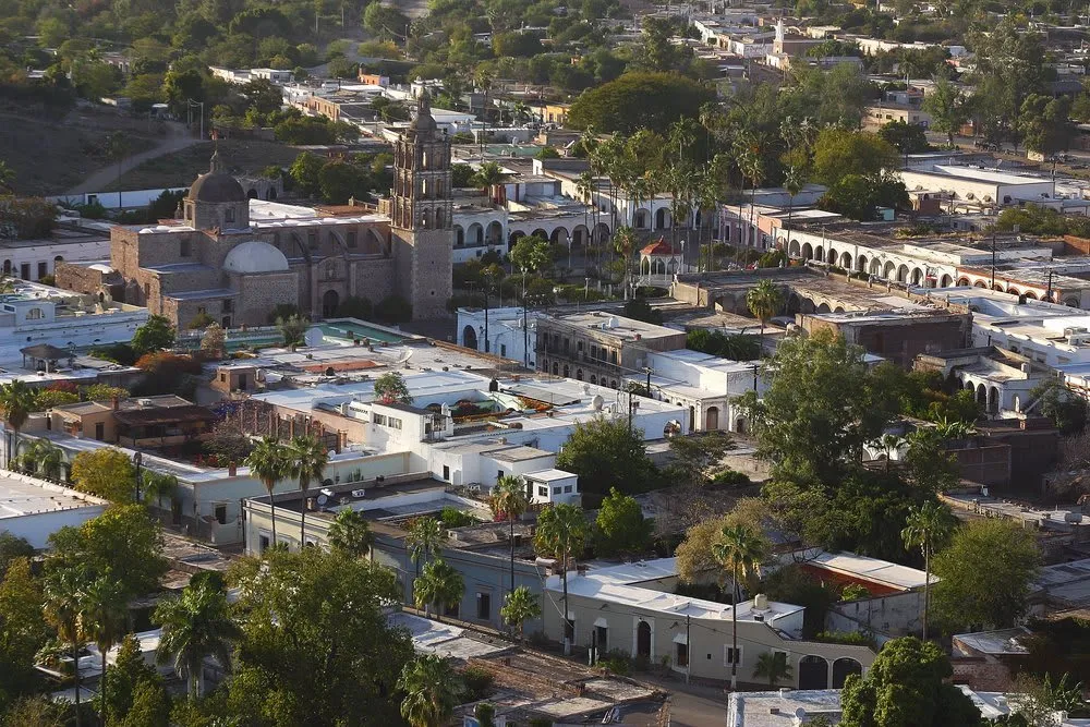 Whitewashed colonial street and tiled rooftops in Álamos