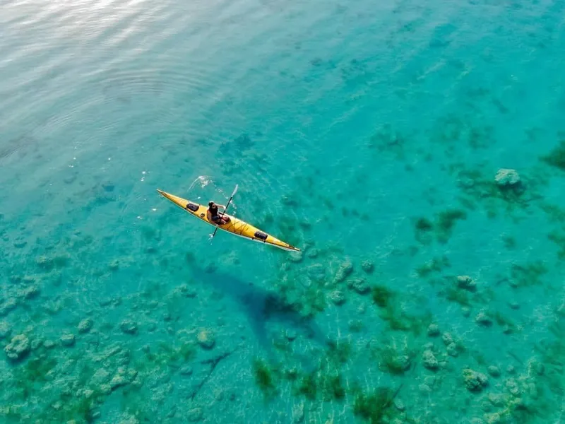 Freshwater swimmers near bright blue shallows on Bacalar's lagoon