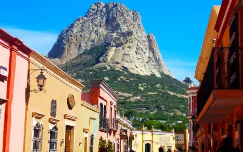 Peña de Bernal rising above green Querétaro countryside in June