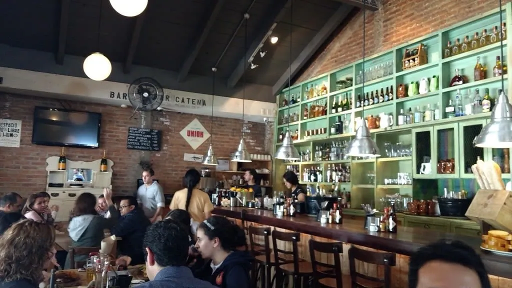 La Docena oyster bar table with seafood plates in Guadalajara