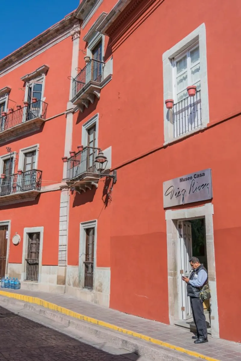 Narrow Guanajuato alley with bright walls, stone steps, and hanging balconies