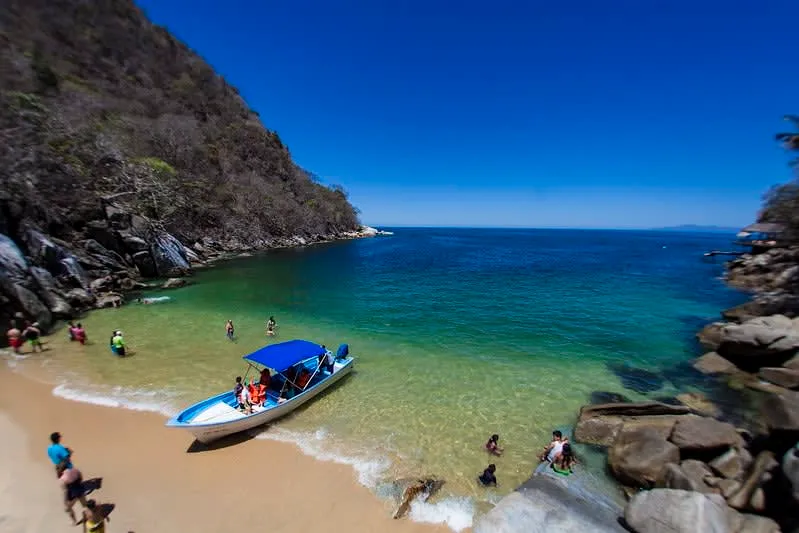 Small turquoise cove at Colomitos Beach surrounded by tropical forest