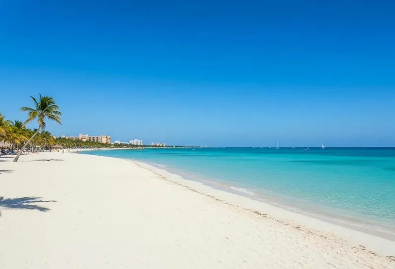 Turquoise waves rolling onto a broad Cancun beach beside the Hotel Zone