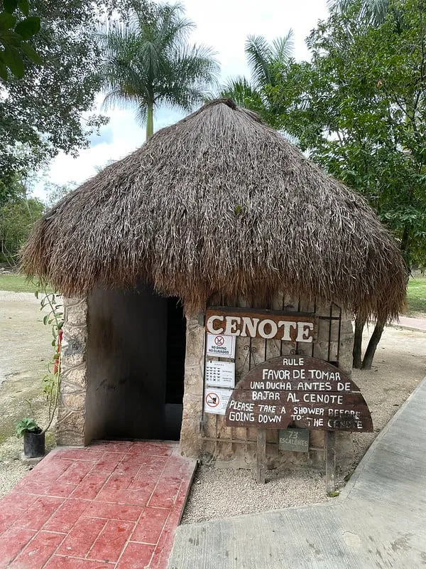 Thatched hut and stone path on the Hacienda San Lorenzo Oxman grounds