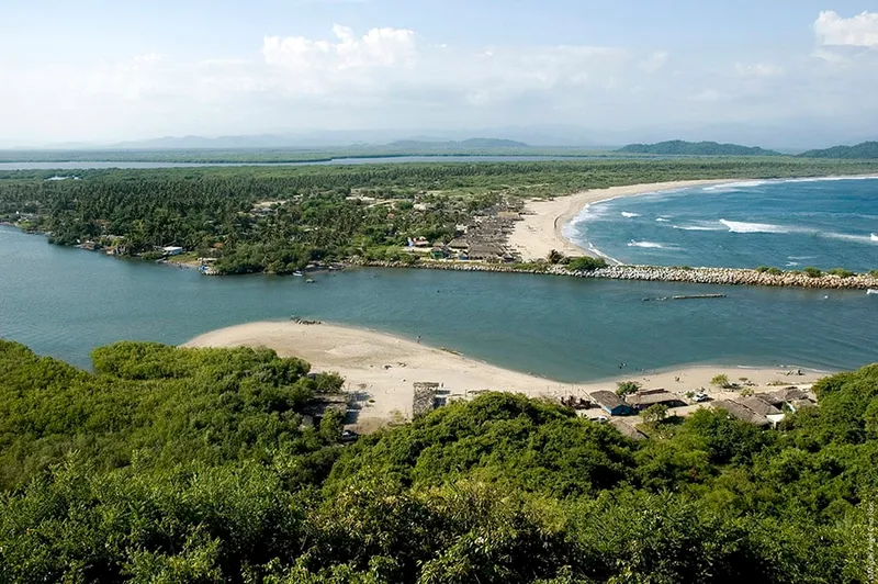 Chacahua lagoon in Oaxaca's national park — boat tour through mangroves leads to a remote Pacific beach, with crocodiles visible in the water
