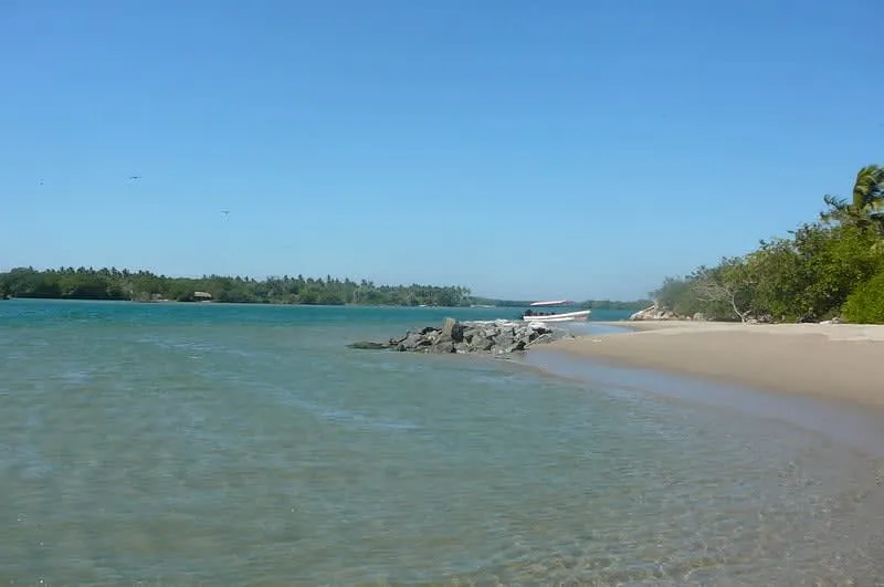 Calm estuary water where travelers swim beside Chacahua lagoon