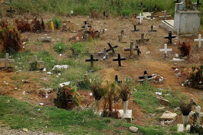 San Juan Chamula cemetery with wooden and cement crosses on a hillside surrounding the ruins of the old San Sebastián church, Chiapas