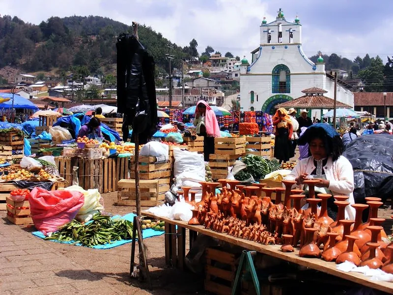 Sunday market in San Juan Chamula with Tzotzil Maya vendors selling textiles, wool garments, and handicrafts in the main plaza