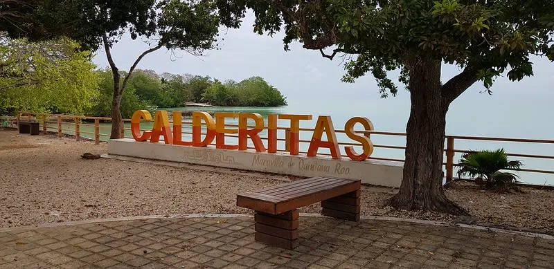 Calderitas shoreline on Chetumal Bay with shallow water and fishing boats