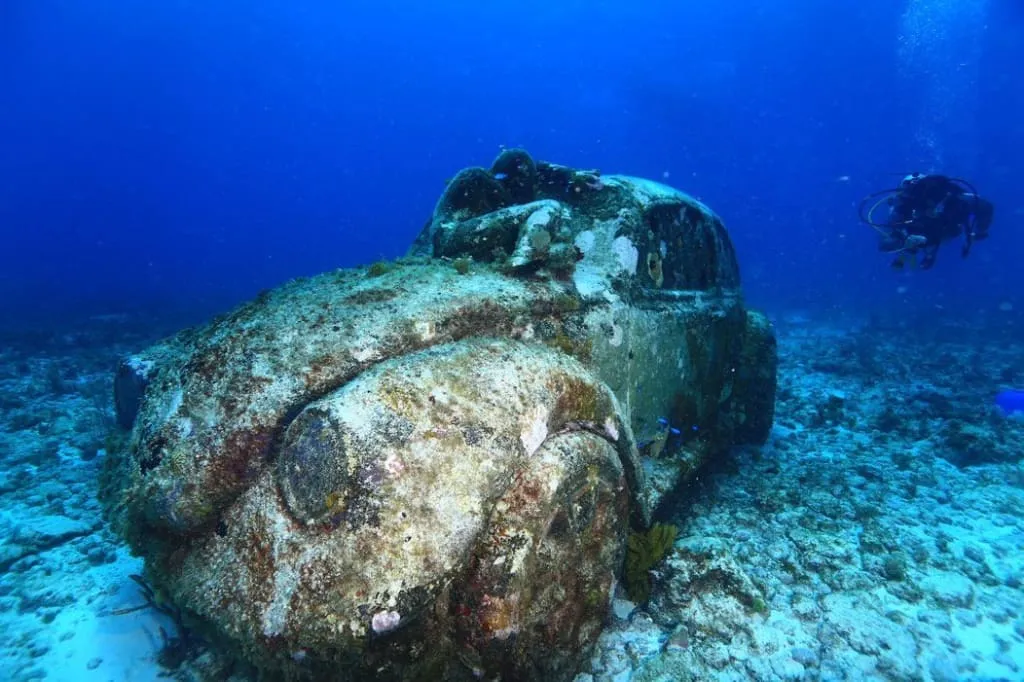 MUSA underwater museum sculpture on the sandy seafloor near Isla Mujeres
