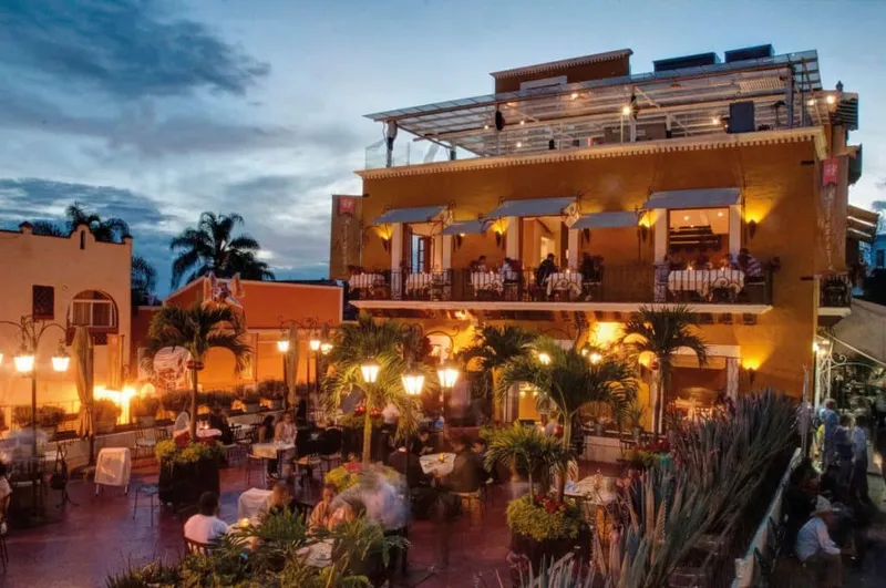 Hotel pool in Cuernavaca surrounded by leafy gardens and shaded seating