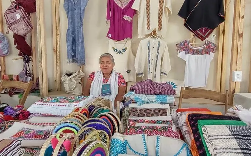 Vendors arranging textiles, produce, and coffee at Cuetzalan's Sunday market