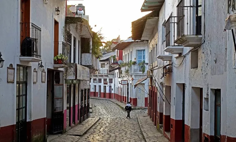 Wet stone lanes and whitewashed buildings in Cuetzalan after a mountain shower