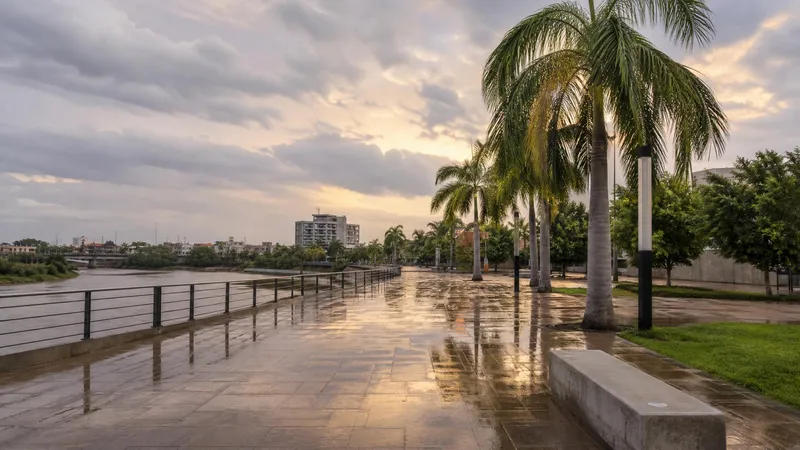 Rain-wet Culiacan riverside walkway with palms and storm clouds in September evening light