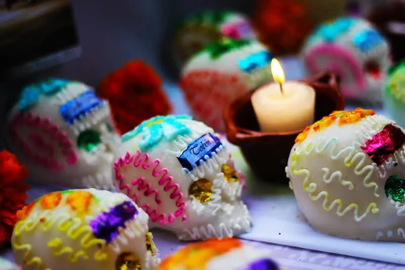 Colorful alfeñique sugar skull candies arranged on a table