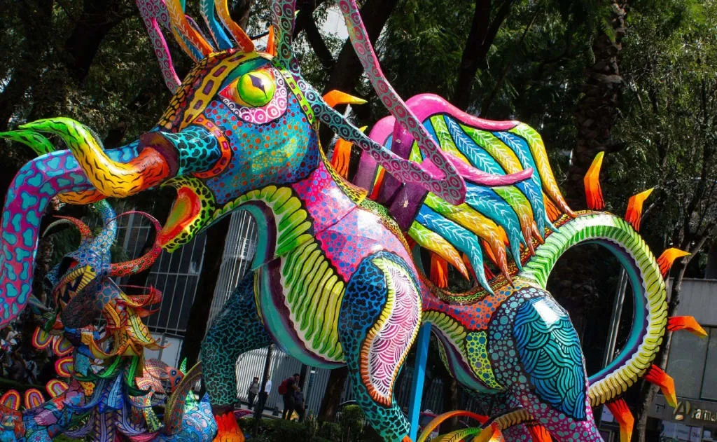 Colorful alebrije-inspired costume with bright animal mask