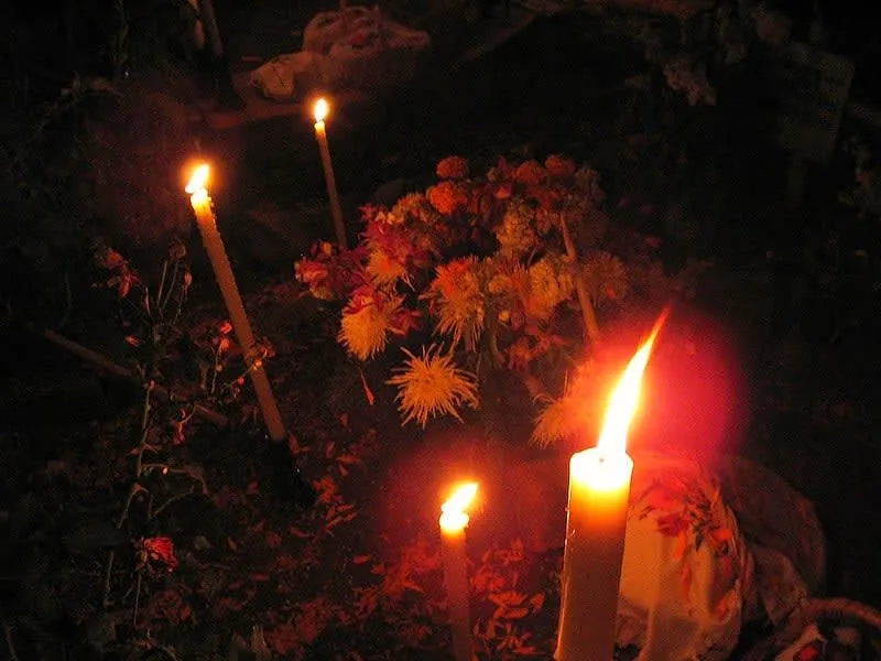 Candlelit Día de los Muertos cemetery vigil in Pátzcuaro, Michoacán — families keep watch through the night on November 1