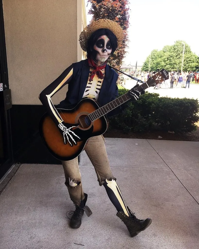 Héctor from Coco costume with straw hat suspenders and guitar