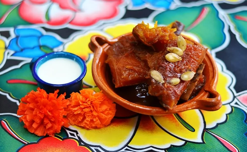 Candied pumpkin in piloncillo syrup served in a clay bowl
