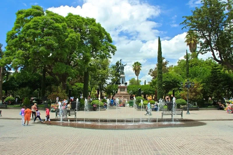 Dolores Hidalgo parish plaza surrounded by green hills and Guanajuato wine country