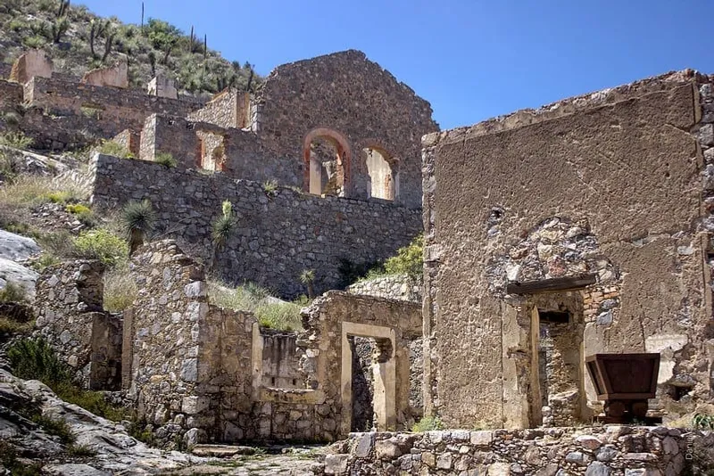Historic Mapimi mine entrance cut into a rocky desert hillside