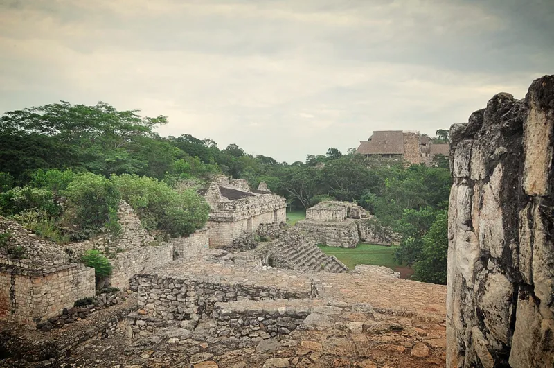 Ancient stone structures and greenery at Ek Balam in Yucatán