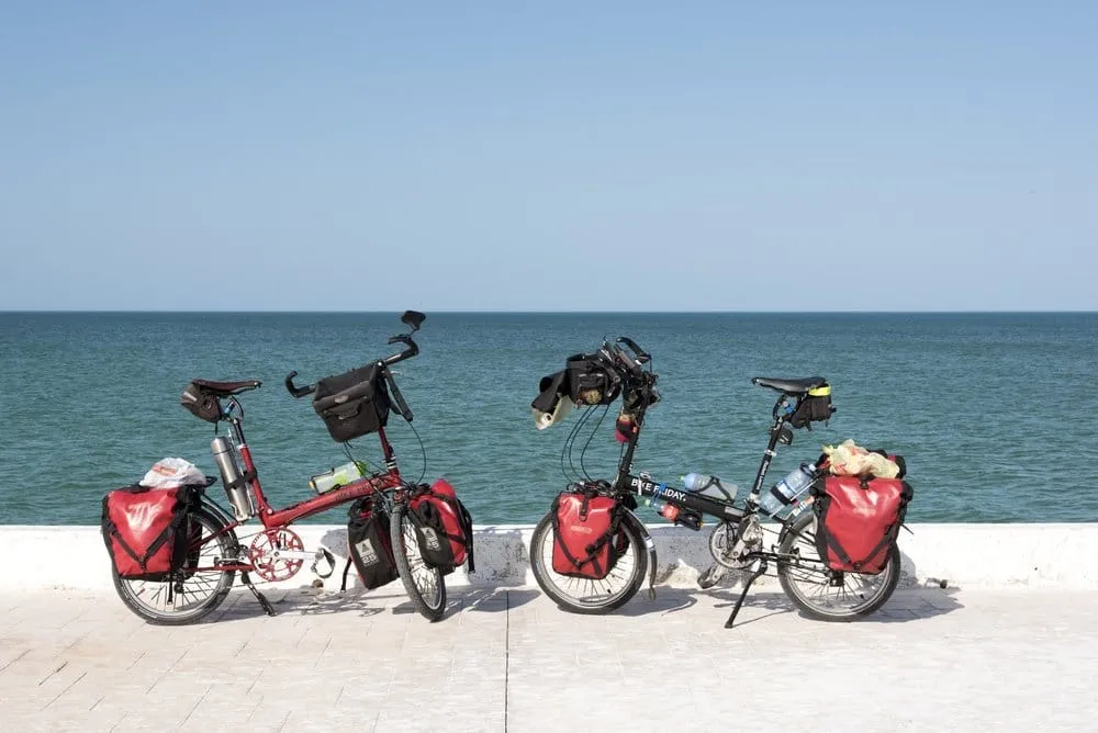 Bicycle-friendly sandy lane with colorful murals in El Cuyo