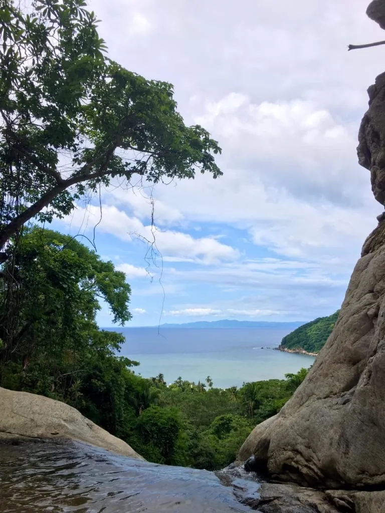 Yelapa beach cove with boats and green hills on Banderas Bay