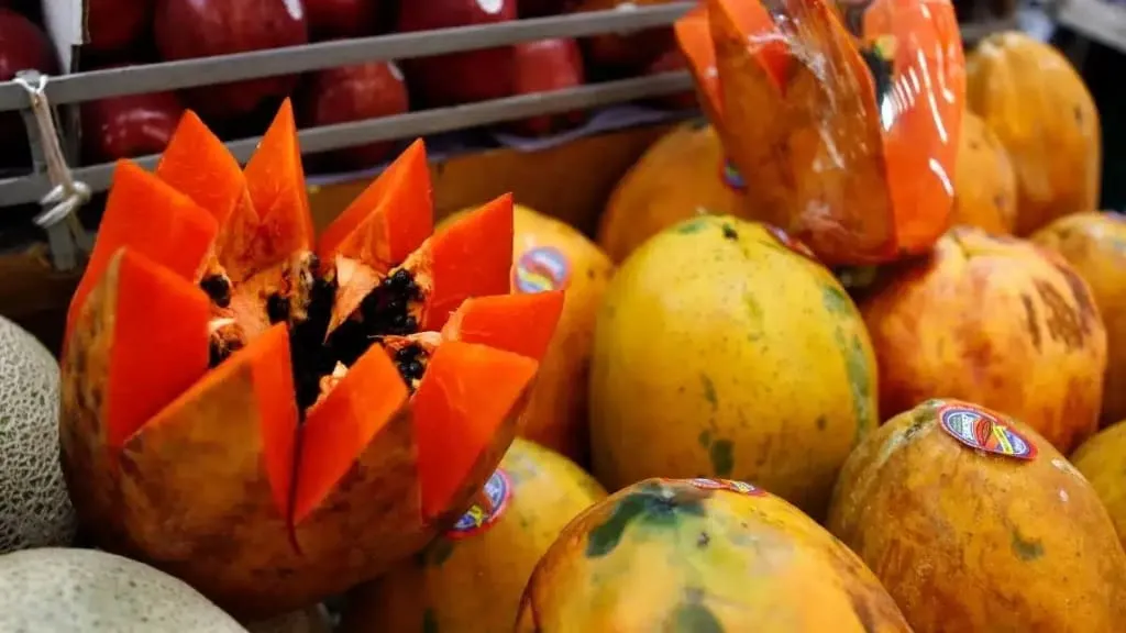 Cut Mexican papaya with orange flesh and black seeds