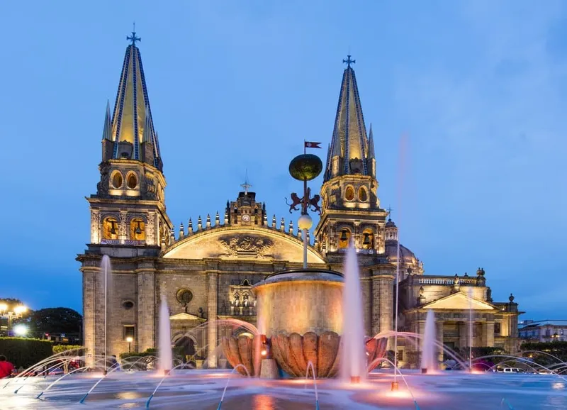 Guadalajara cathedral towers and plaza buildings under a warm May sky
