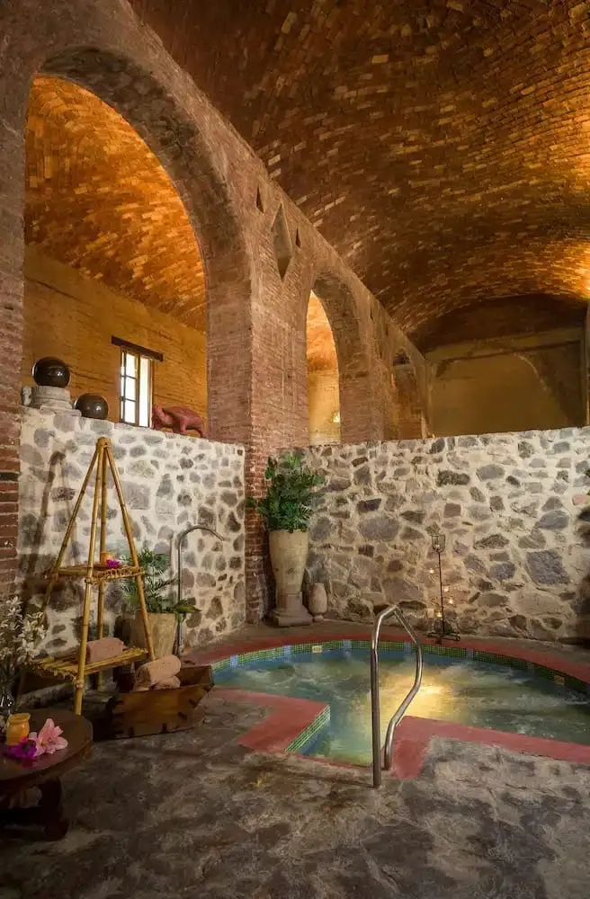 Hacienda El Carmen corridor with arched columns and a landscaped courtyard