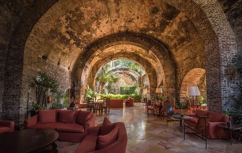 Restored Mexican hacienda courtyard with stone arches and colonial-era walls