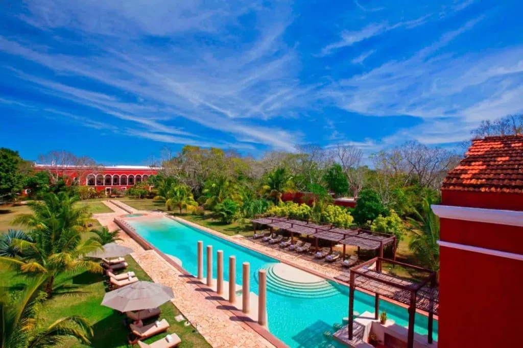 Hacienda Temozon Sur pool terrace beside restored stone buildings in Yucatan