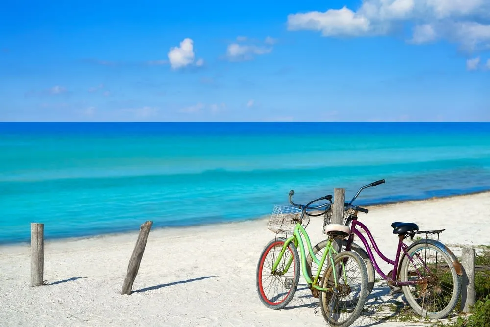 Holbox Island shoreline with shallow blue water and white sand