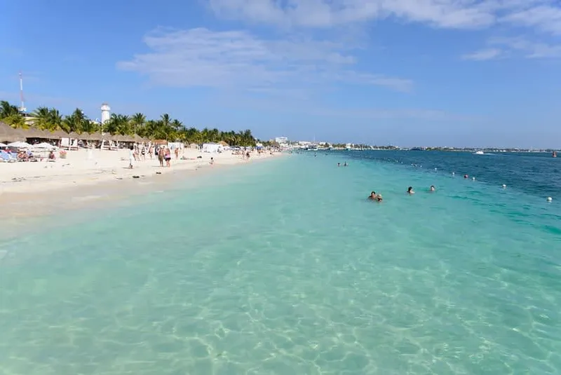 Soft sand and shallow blue water along the Isla Mujeres coastline