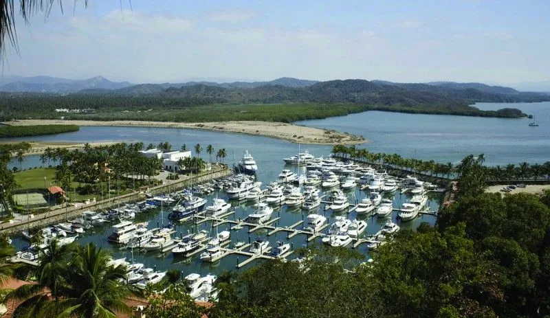 Pacific coast near Manzanillo after the inland drive from Colima through August rainy-season green hills
