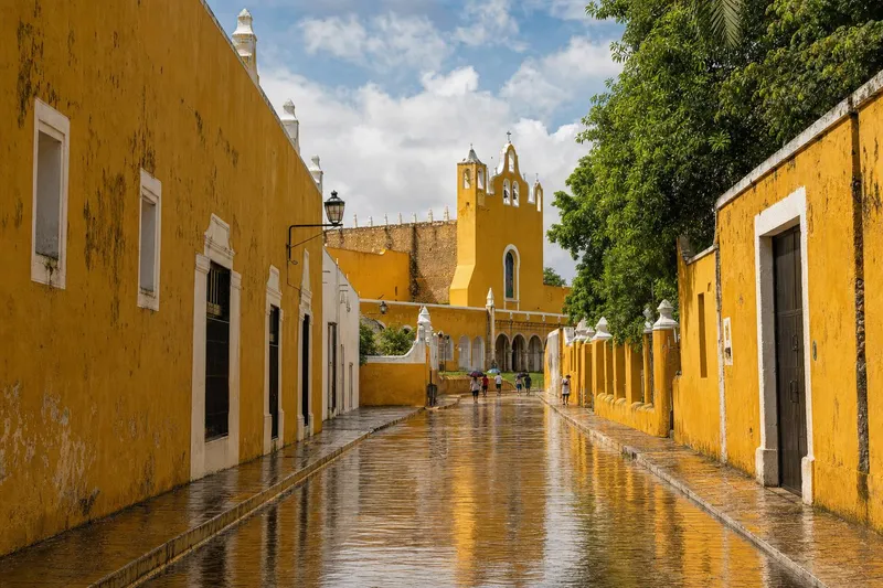 Wet yellow colonial street in Izamal after an August rainy-season shower