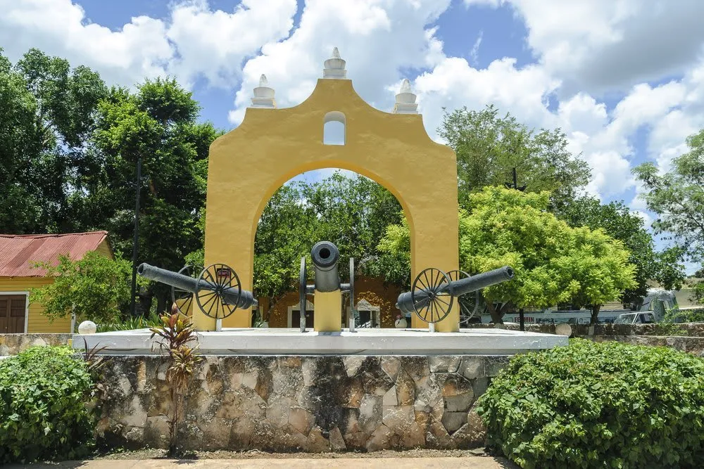 Yellow colonial buildings and stone street in historic Izamal
