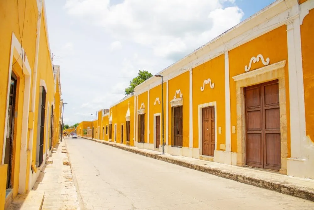 Yellow facades and cobblestone street in central Izamal