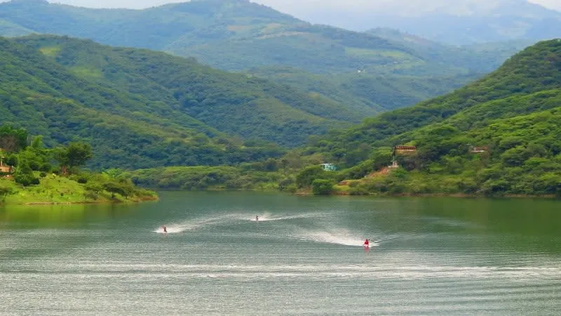 Jalpan de Serra dam in August with green hills, humid weather, and flexible rainy-season route planning