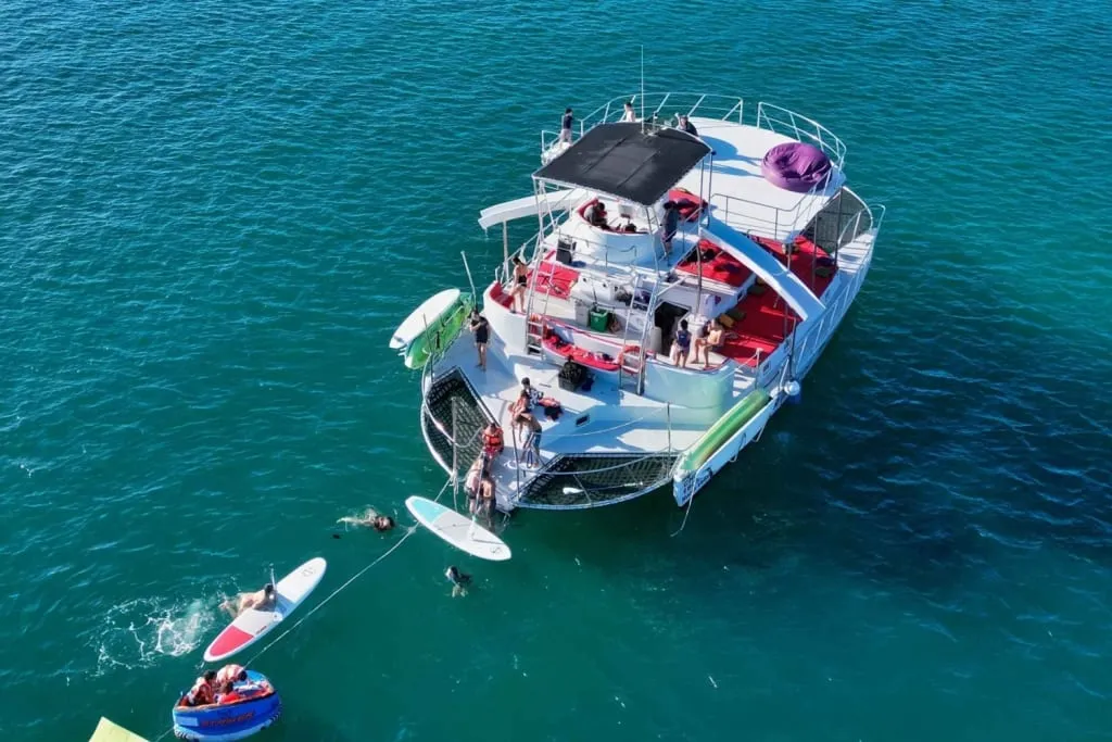 Small boat crossing the blue water of Banderas Bay