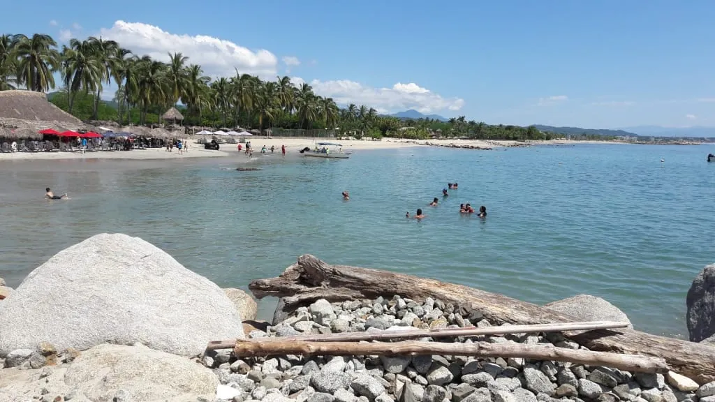 Calm water and pale sand at La Manzanilla Beach