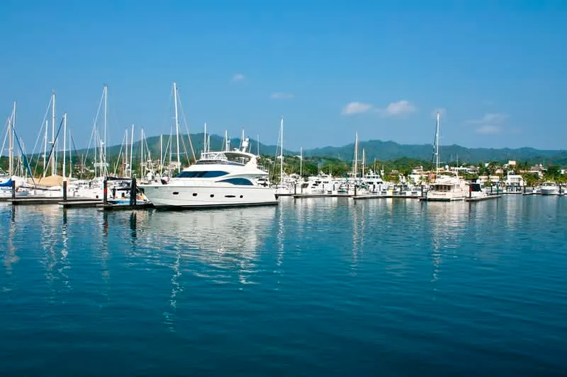 Sailboats docked along a Riviera Nayarit marina walkway