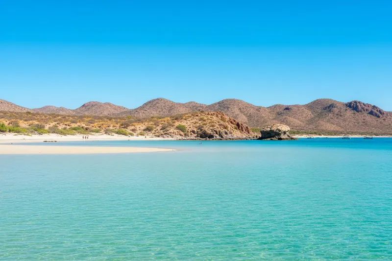 Balandra Beach shallows with pale sand and Baja desert hills near La Paz