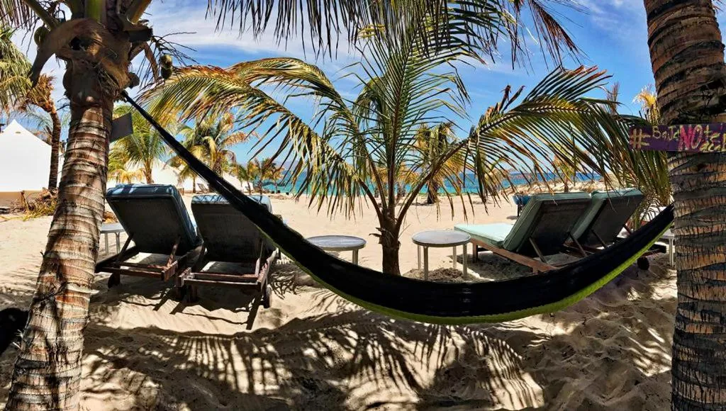 Beach club seating and shaded lounge area on the sand in La Ventana