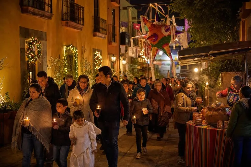 Candlelit Las Posadas procession in Mexico with families walking through decorated streets