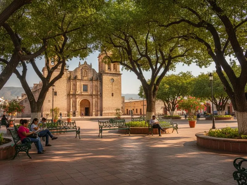 Shaded benches and arcades around Linares Plaza de Armas during a hot August afternoon